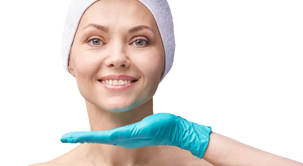 Smiling woman in spa headband getting a skincare assessment at a dermatology clinic, examined by a professional in blue gloves.