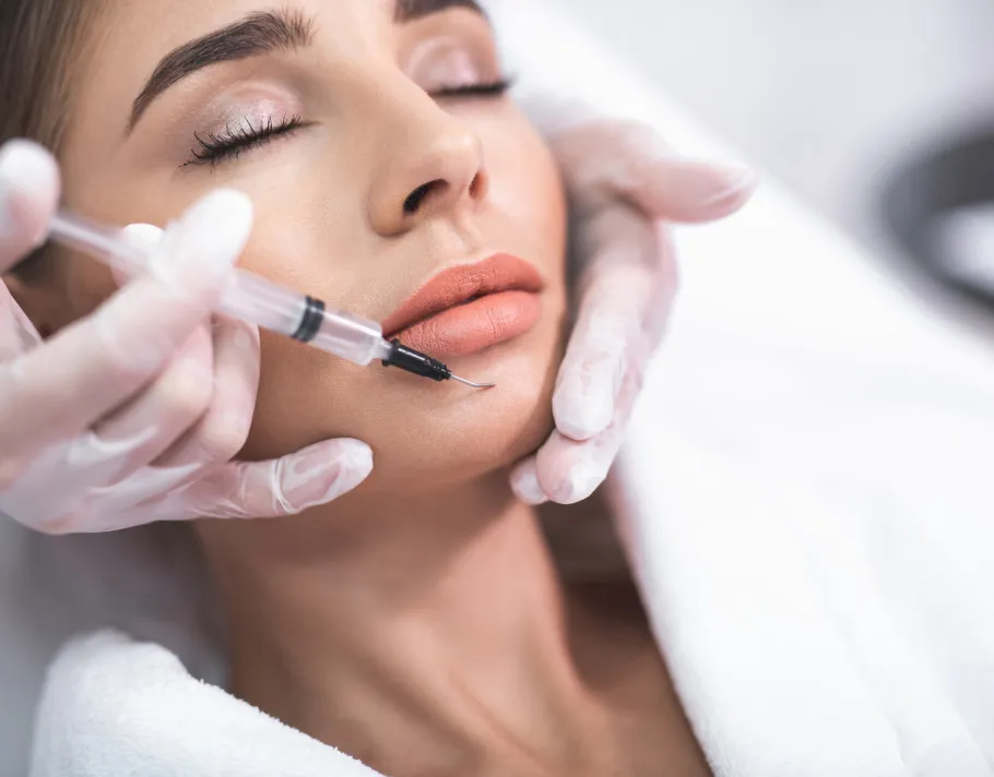 Woman receiving professional facial treatment in calm clinical spa setting