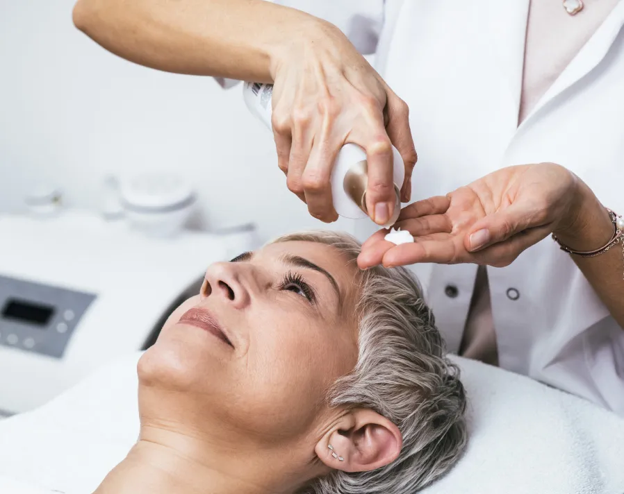 An older woman during a chemical peel treatment - Art of Dermatology