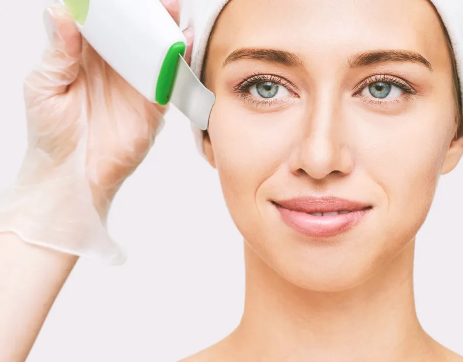 Professional ultrasonic facial treatment for deep skin cleansing and exfoliation at a dermatology clinic for healthy, glowing skin.