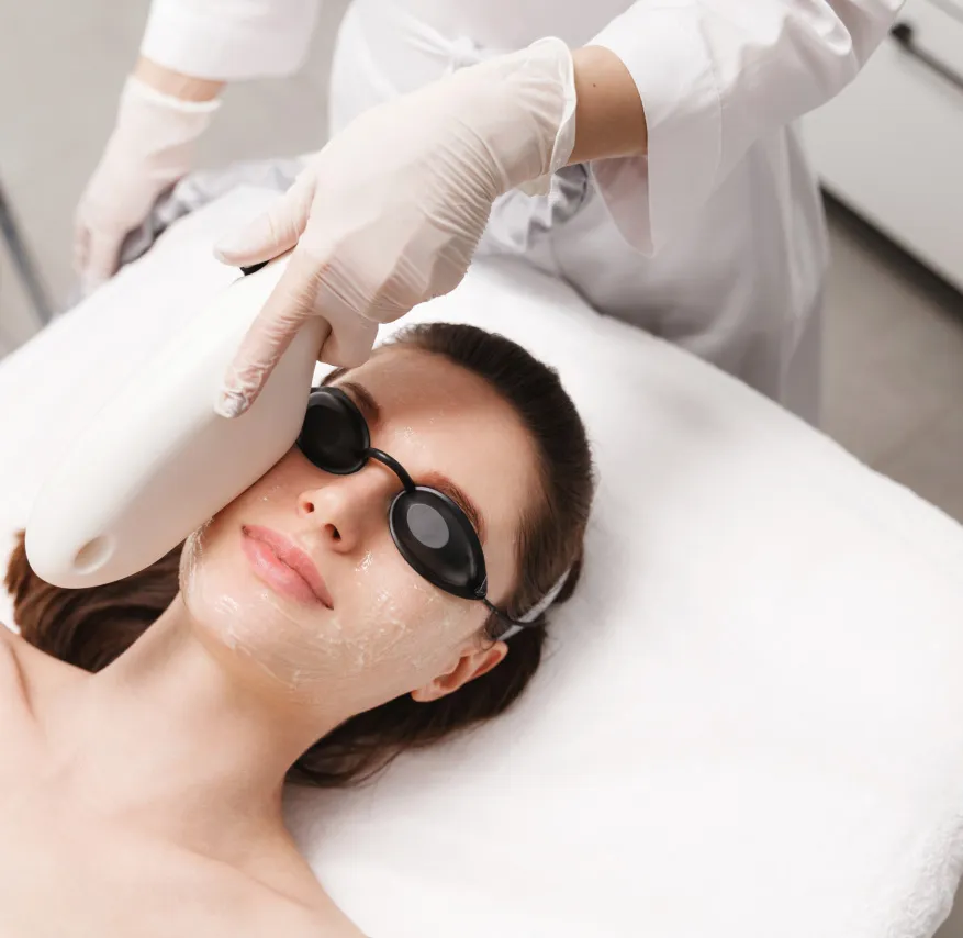 Woman receiving Clear + Brilliant laser facial treatment for skin rejuvenation and glowing complexion