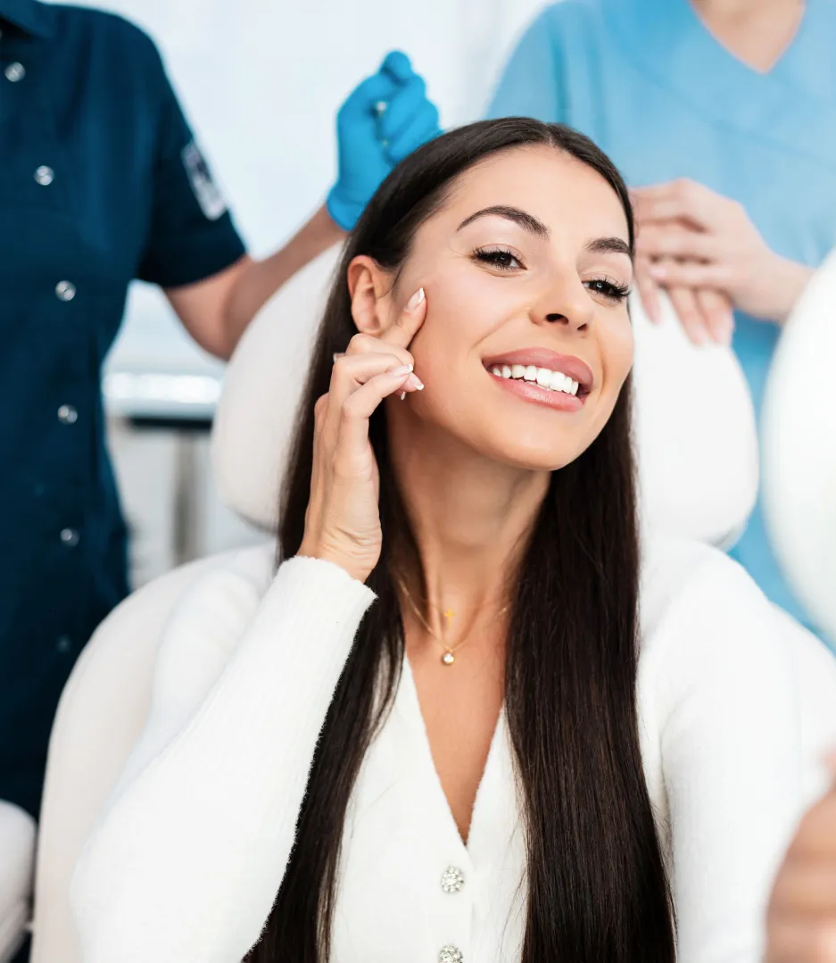 Happy woman admiring results after cosmetic dermatology treatment for youthful, glowing skin at a professional skin clinic.