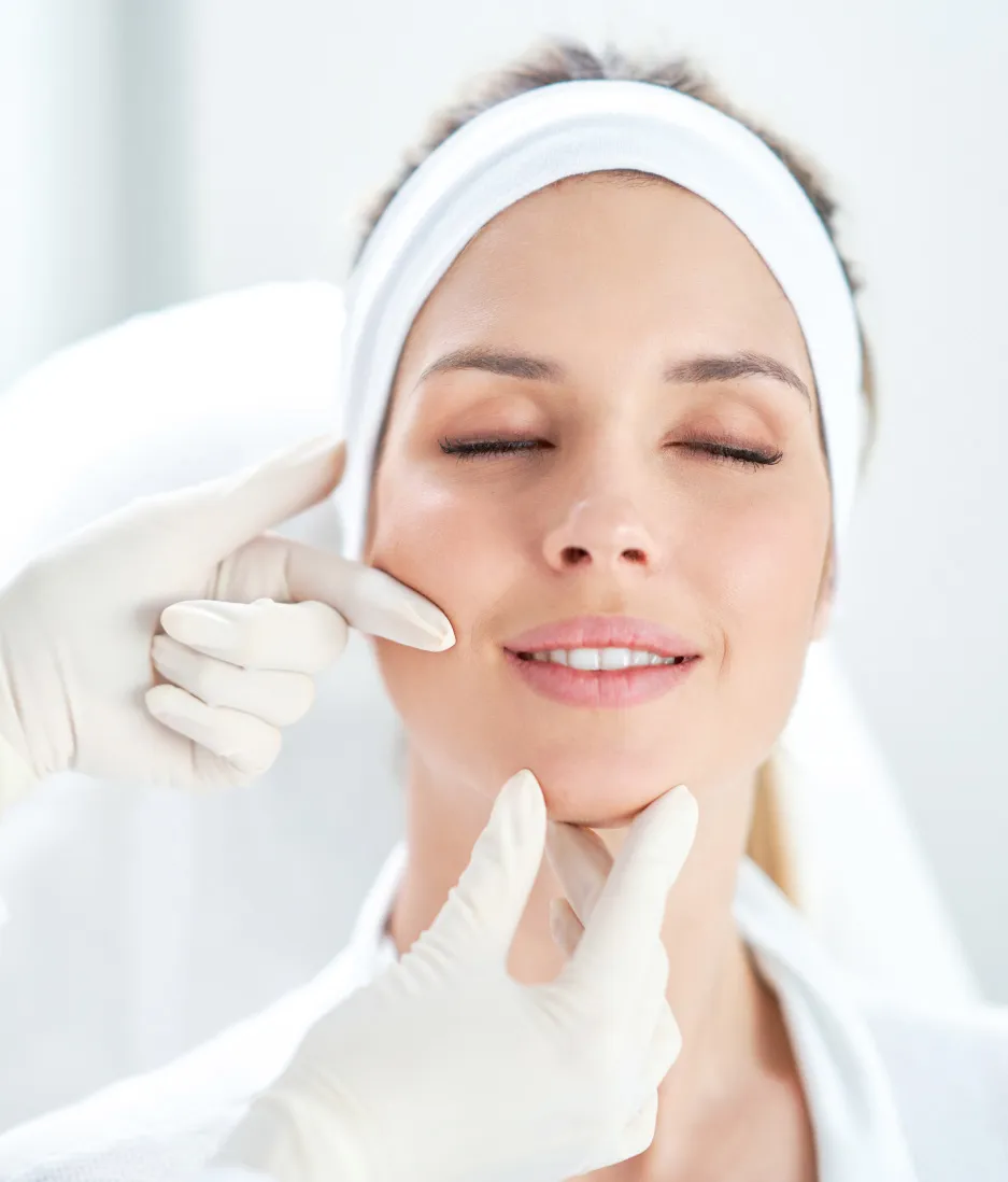 Dermatologist performing a professional skin analysis and facial treatment for glowing, healthy skin at a dermatology clinic.