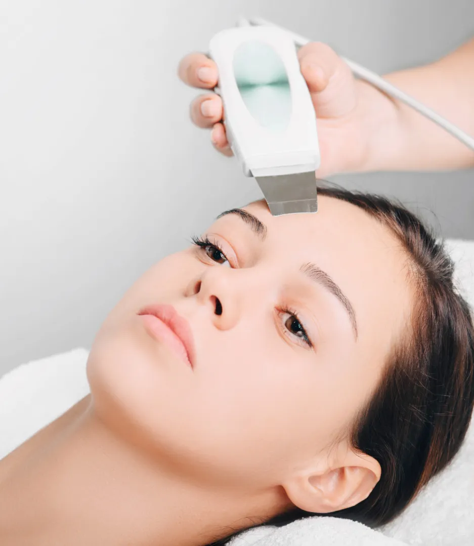 Woman with clear, glowing skin after a professional dermatology treatment.
