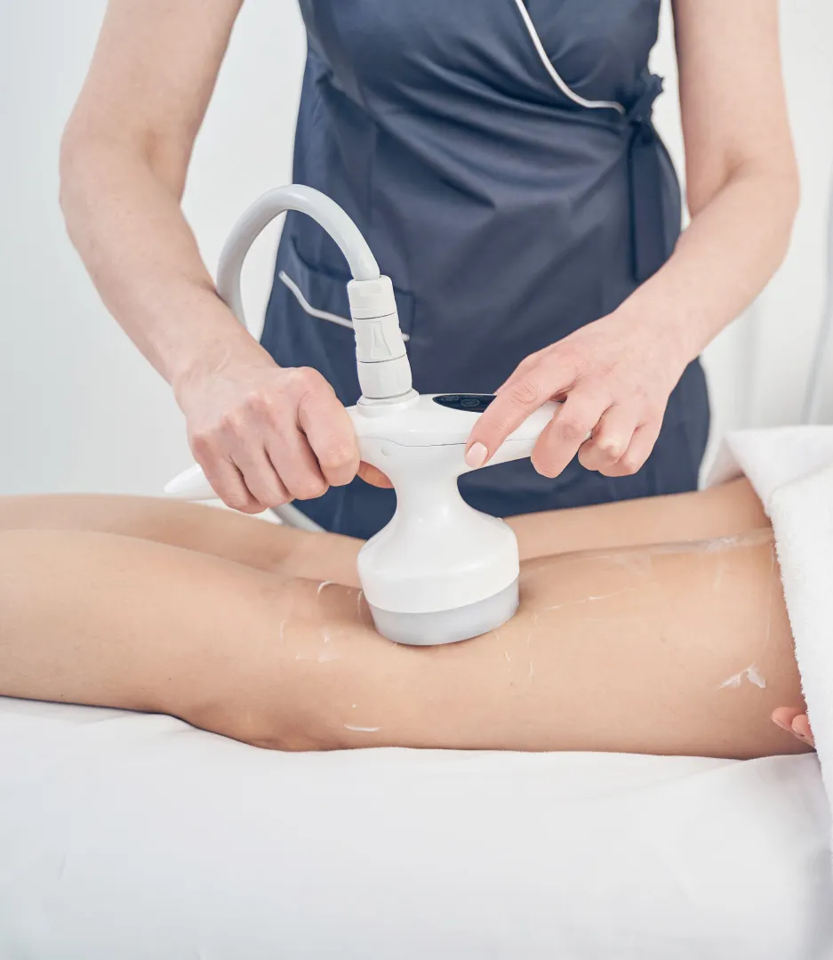 Professional performing SkinTyte treatment on client's thigh